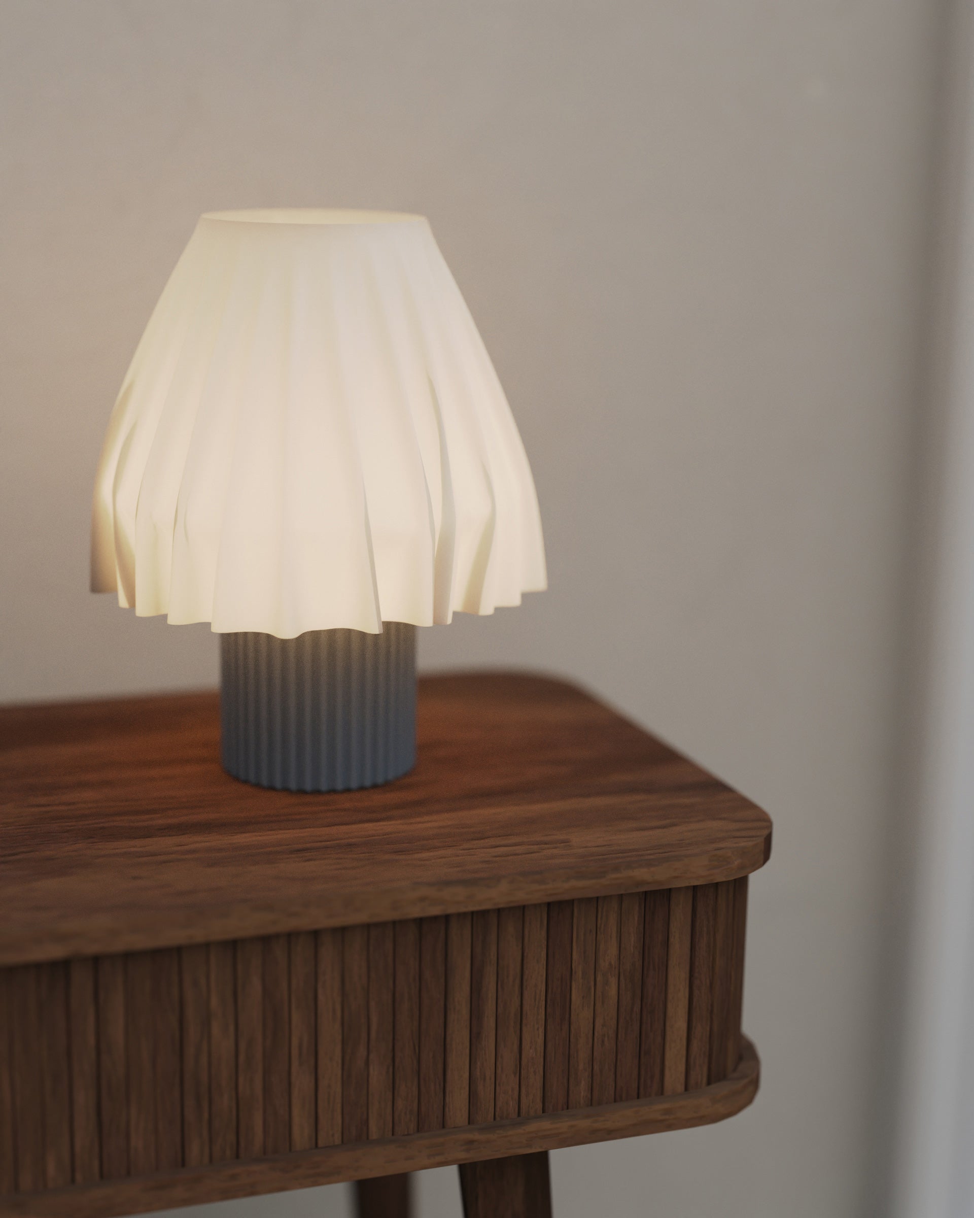 The Volute - Graphite table lamp by Mouchoir, featuring a digital craft design mimicking frozen silk fabric on a wooden table.